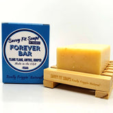 A box of Savvy Fit Soaps Forever Bar in Ylang, Amyris, and Juniper with an open soap, showcasing its plant-based, USA-made, and aromatic skincare formula.